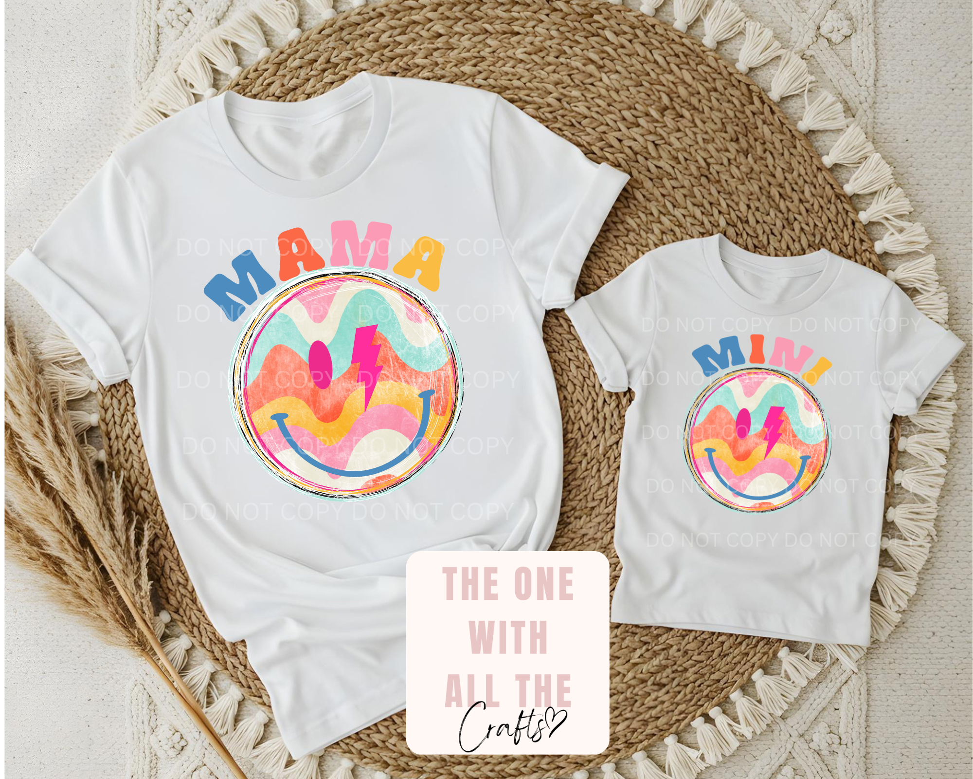White t-shirts with colorful designs and text on a textured surface