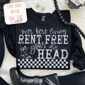 Black sweatshirt with humorous text design on a white surface with accessories.