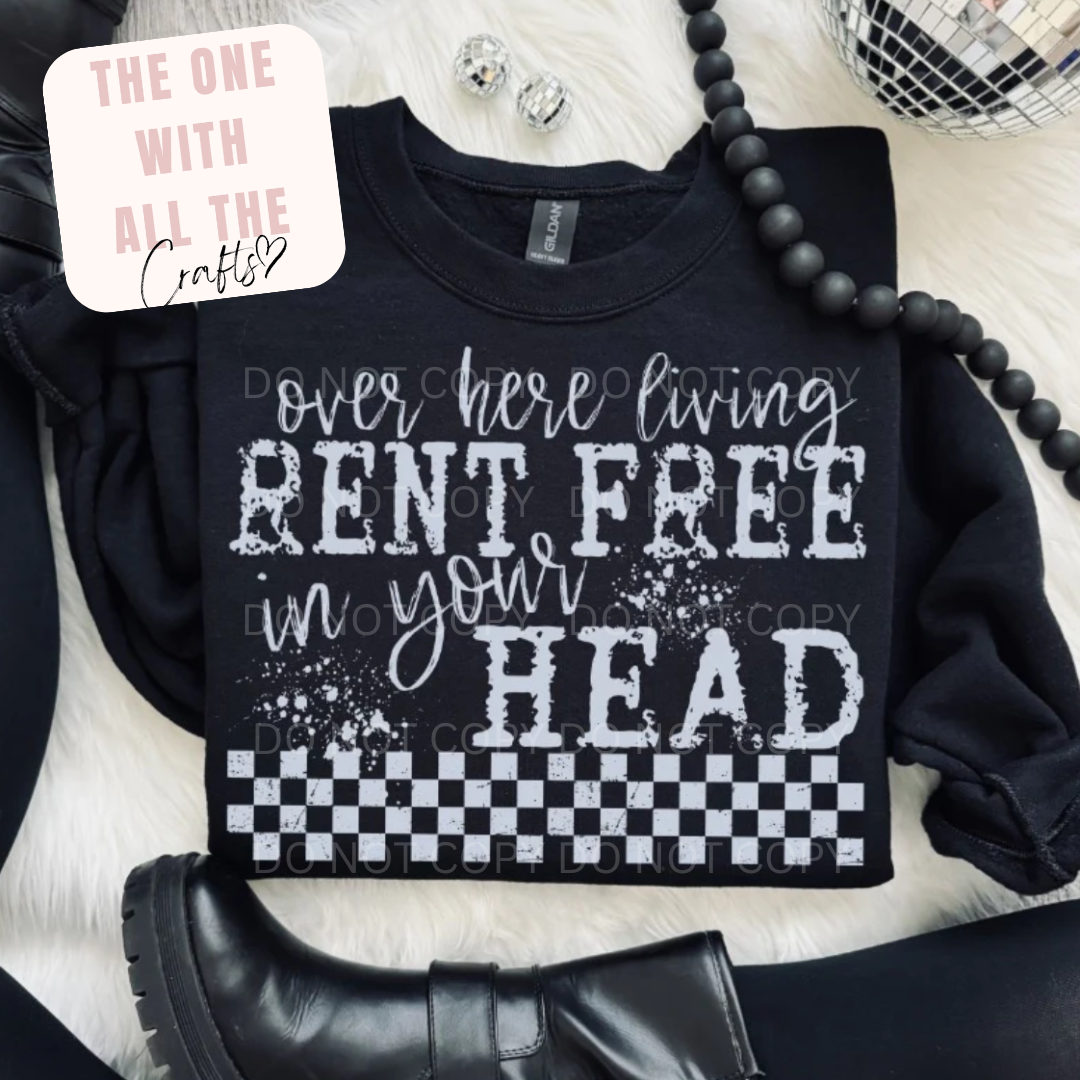Black sweatshirt with humorous text design on a white surface with accessories.