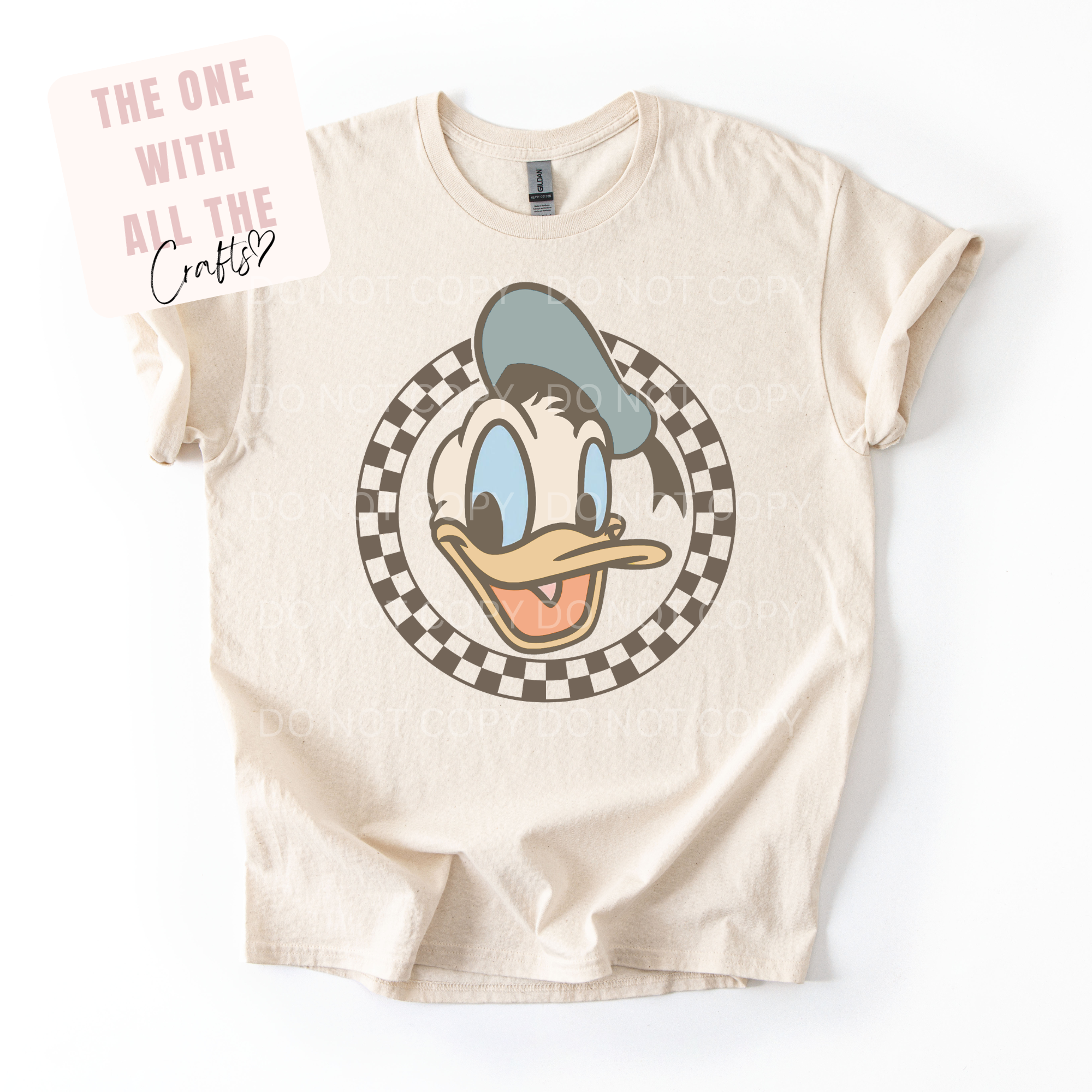 Beige t-shirt with cartoon character design on a white background