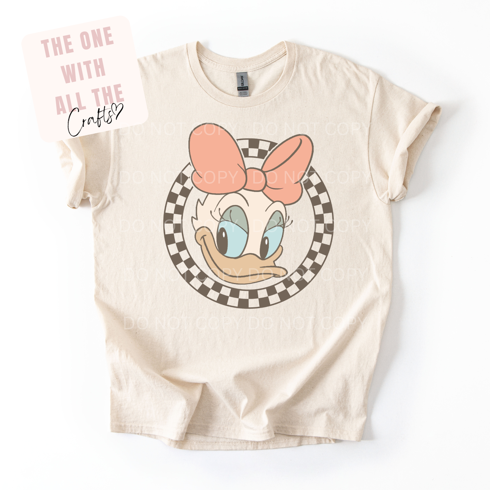 Beige t-shirt with cartoon character design on a white background
