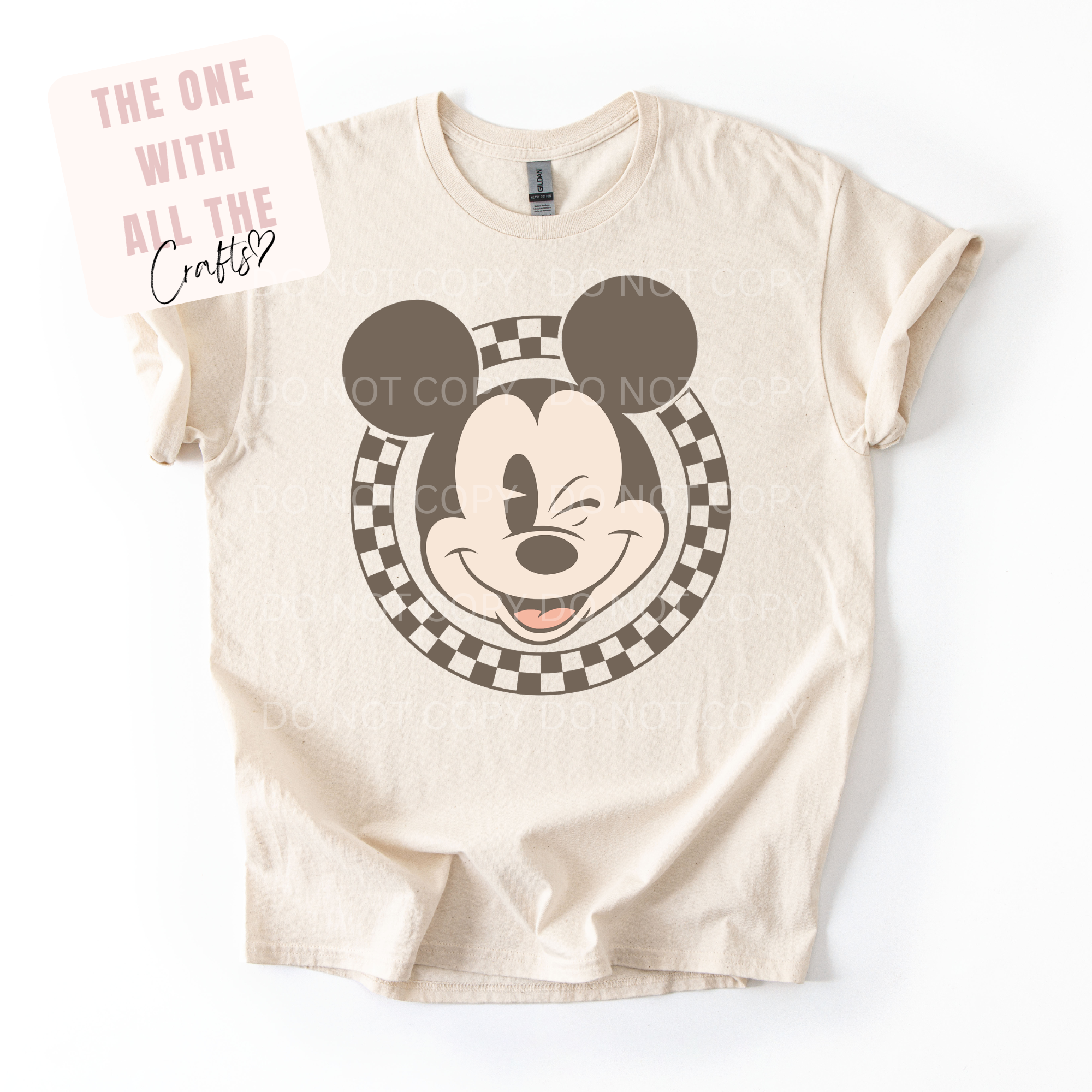 Beige t-shirt with a graphic of a character's face on a white background