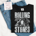 Black t-shirt with 'Rolling Stones' graphic design on blue jeans