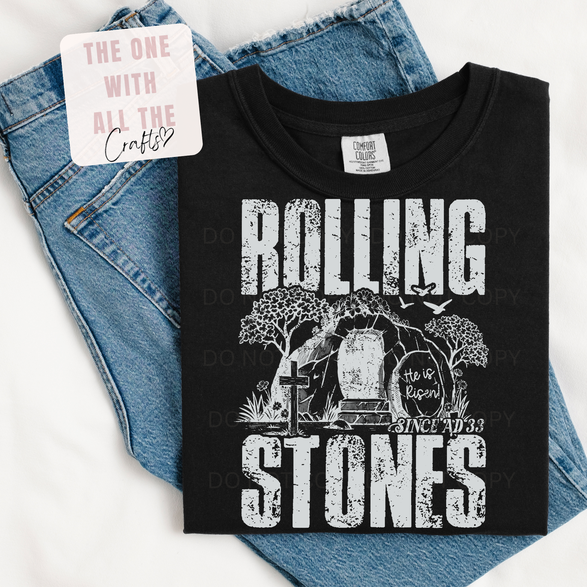 Black t-shirt with 'Rolling Stones' graphic design on blue jeans