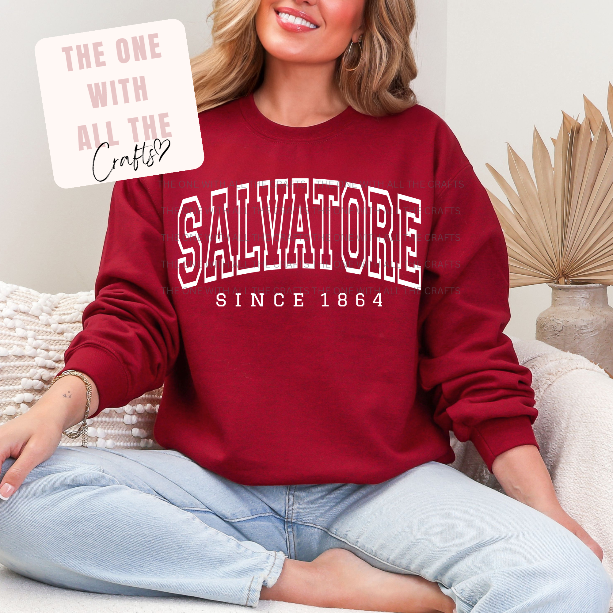 Person wearing a red sweatshirt with 'Salvatore Since 1864' text, sitting on a couch.