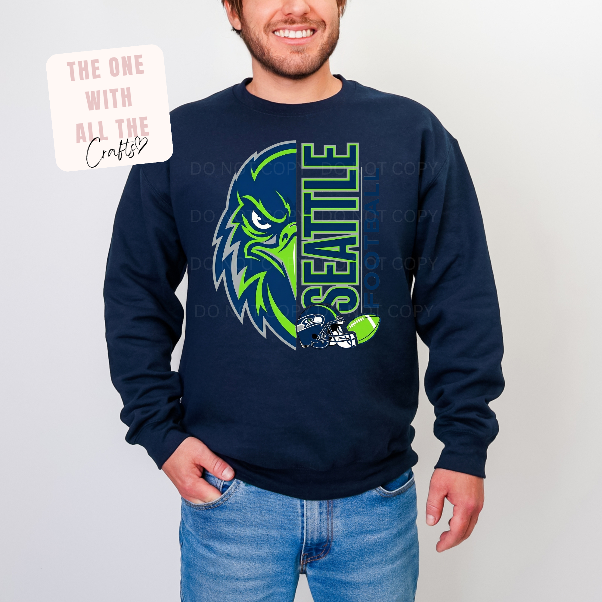 Person wearing a navy blue sweatshirt with a green and blue graphic design on a plain background