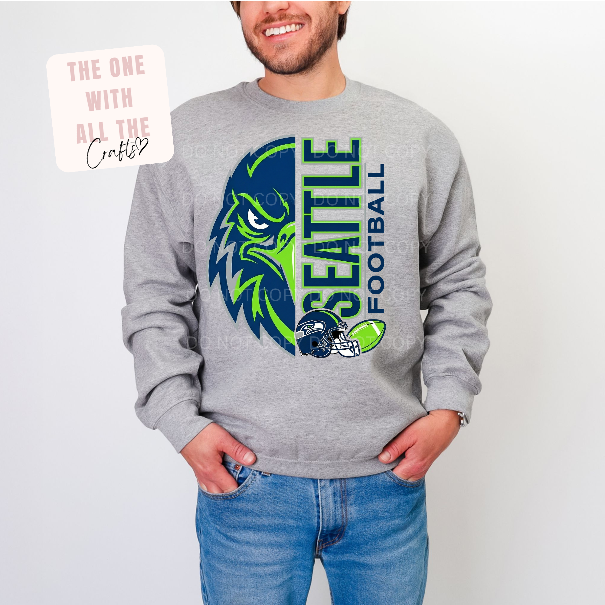Person wearing a gray sweatshirt with Seattle Seahawks logo