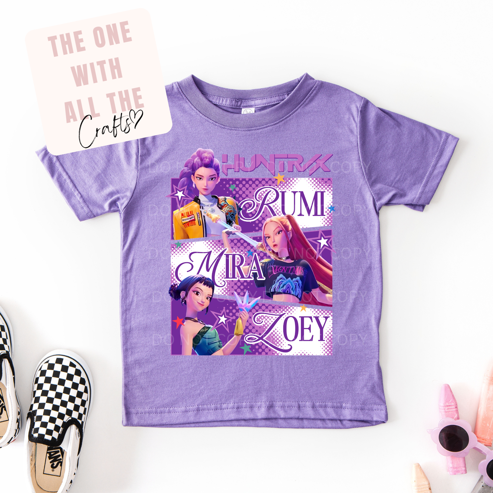Purple t-shirt with character graphics and names on a white background