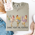 Gray sweatshirt with colorful chicken designs and text 'Shake Your Tail Feather' on a white background.