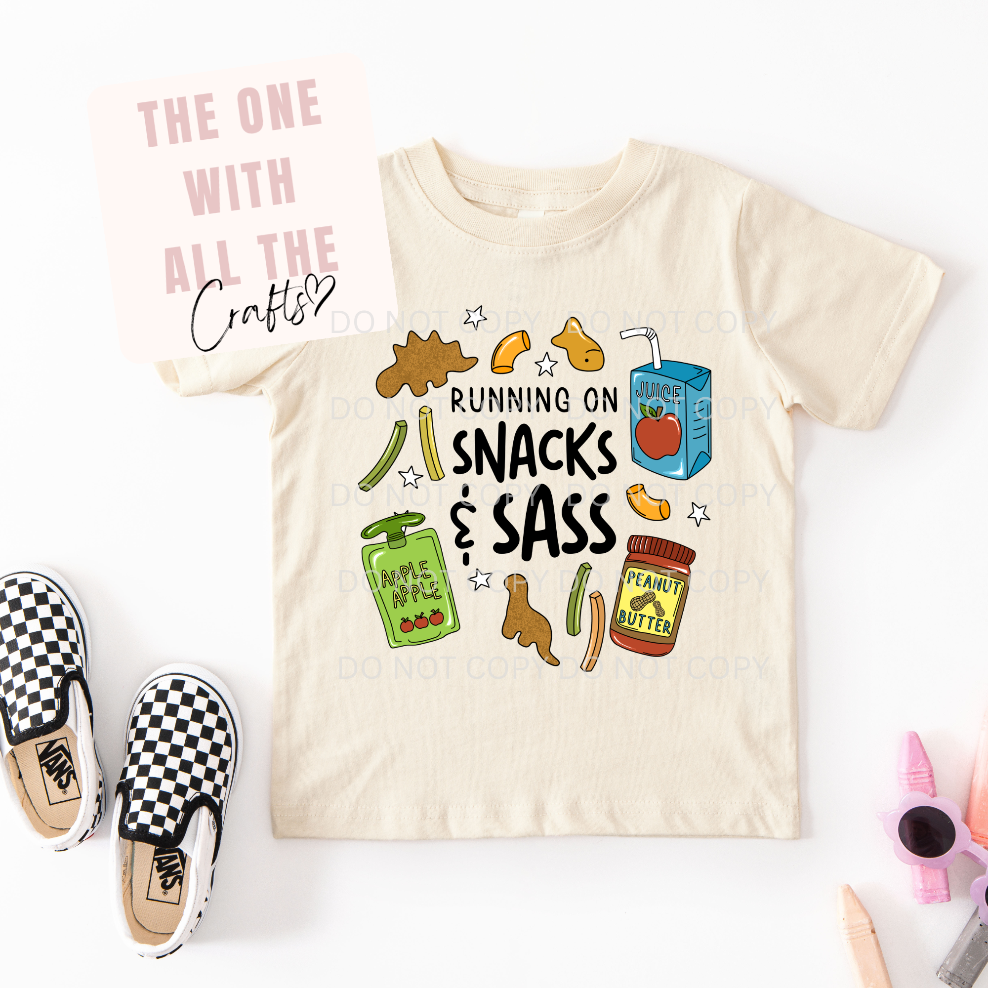 Beige t-shirt with colorful graphics and text on a white background