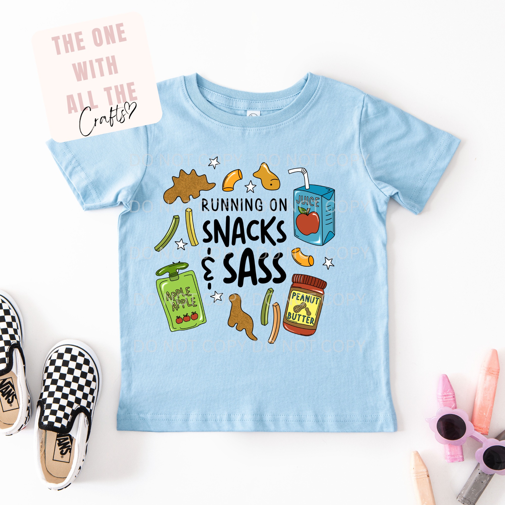 Light blue t-shirt with snacks and sass graphic on a white background