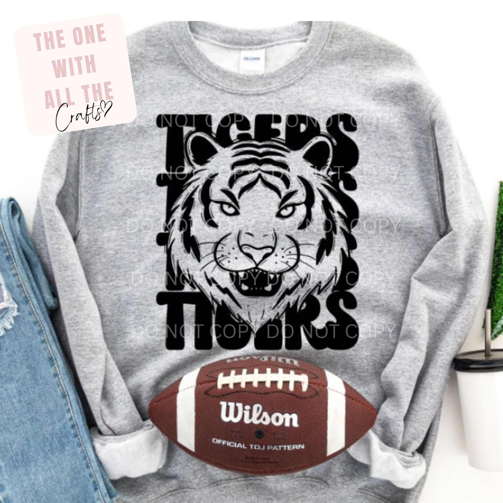 Gray sweatshirt with tiger graphic and 'Tigers' text, next to a Wilson football.