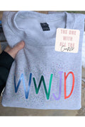 Gray sweatshirt with colorful 'WWJD' text and a tag on a neutral background