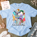 Light blue t-shirt with colorful graphic design on a textured surface