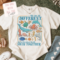 White t-shirt with underwater animal design and text on a textured surface