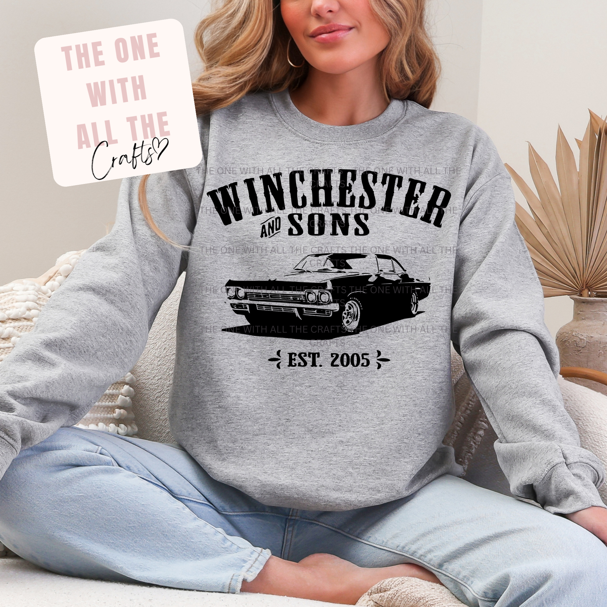 Person wearing a gray sweatshirt with 'Winchester and Sons' graphic design.