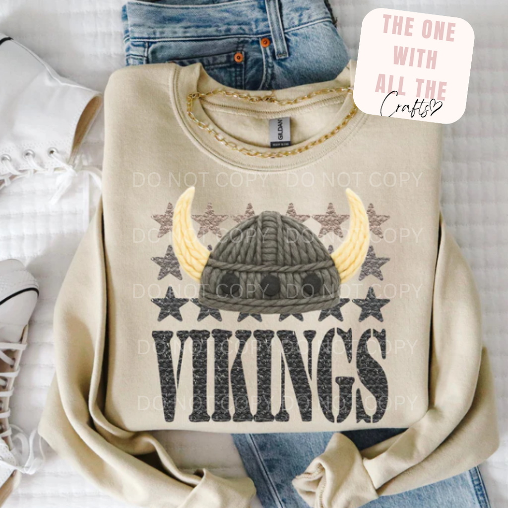 Beige sweatshirt with Viking helmet design and 'Vikings' text on a white background
