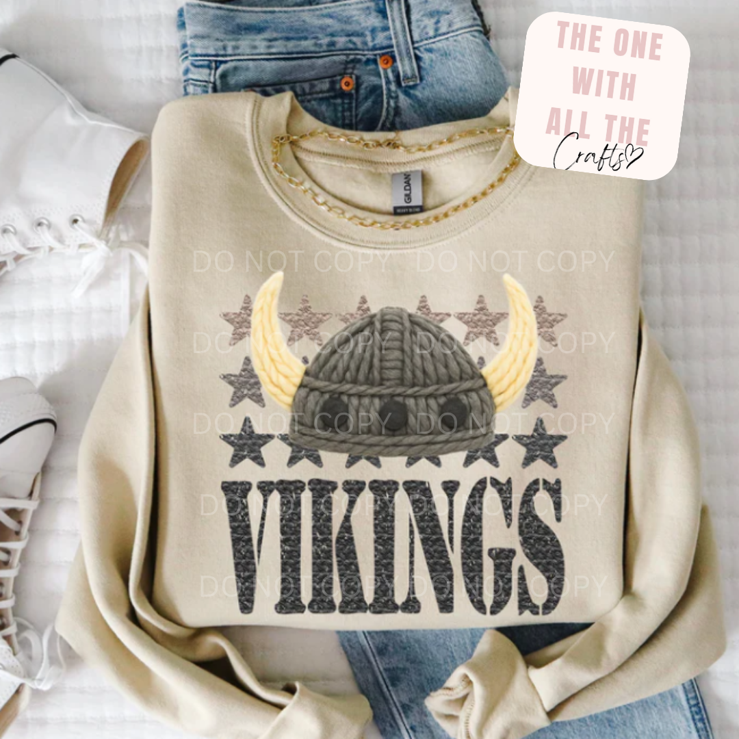 Beige sweatshirt with Viking helmet design and 'Vikings' text on a white background