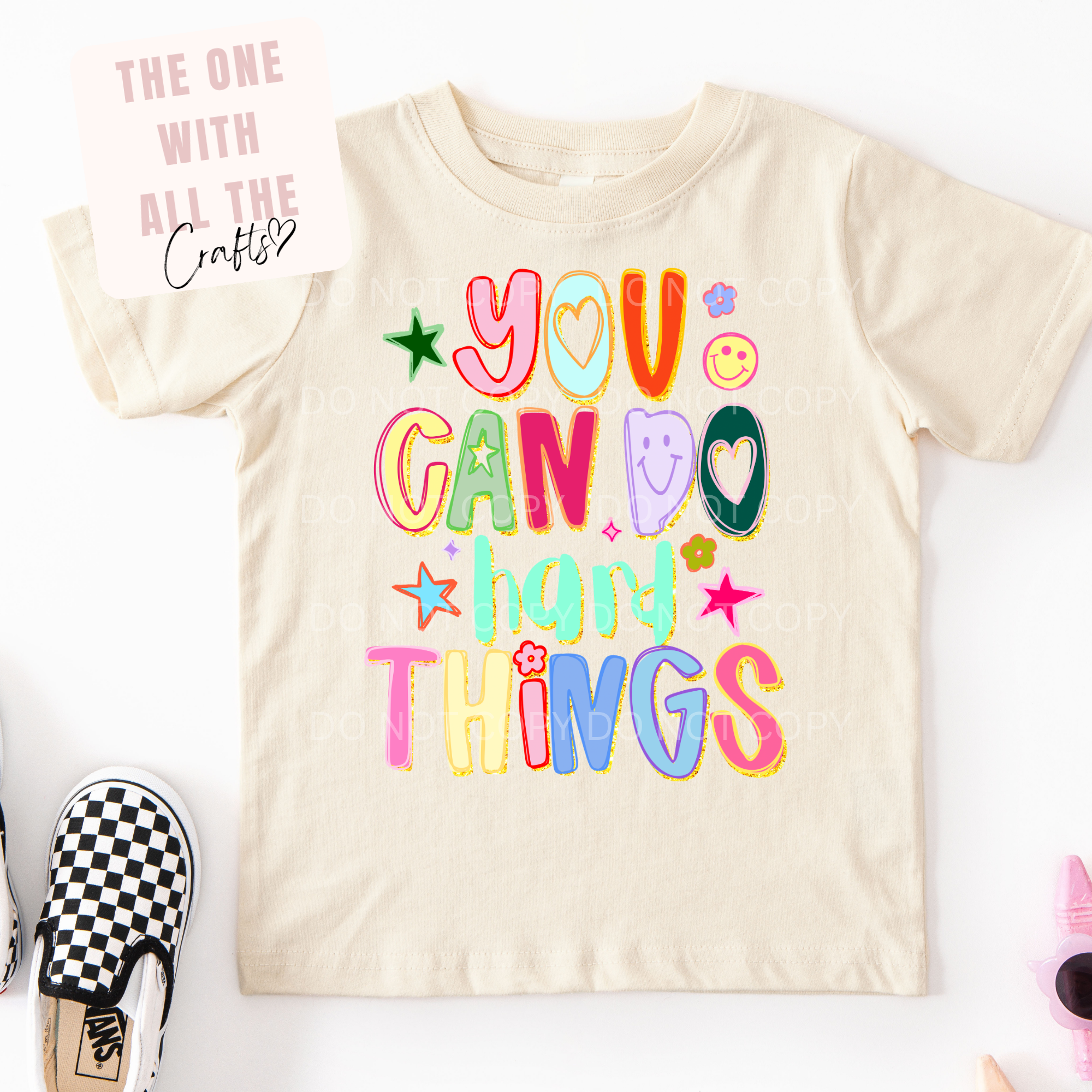 White t-shirt with colorful graphic design featuring a heart and text on a white background.