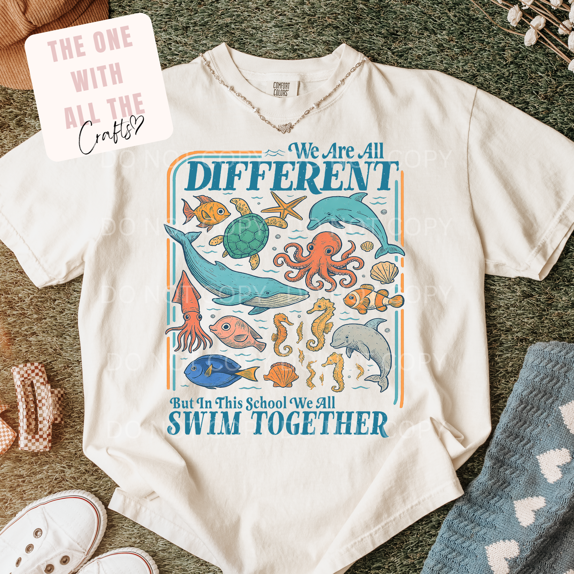 White t-shirt with underwater animal design and text on a textured surface